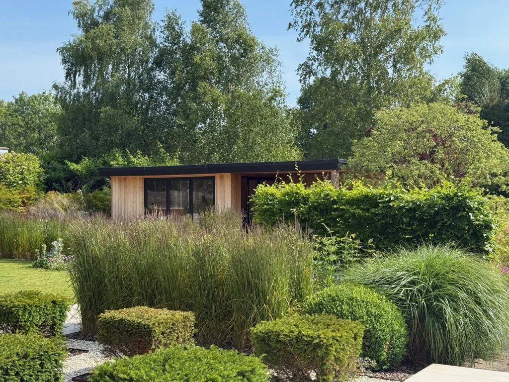 Landscaped garden with raised planters, ornamental grasses and composite decking