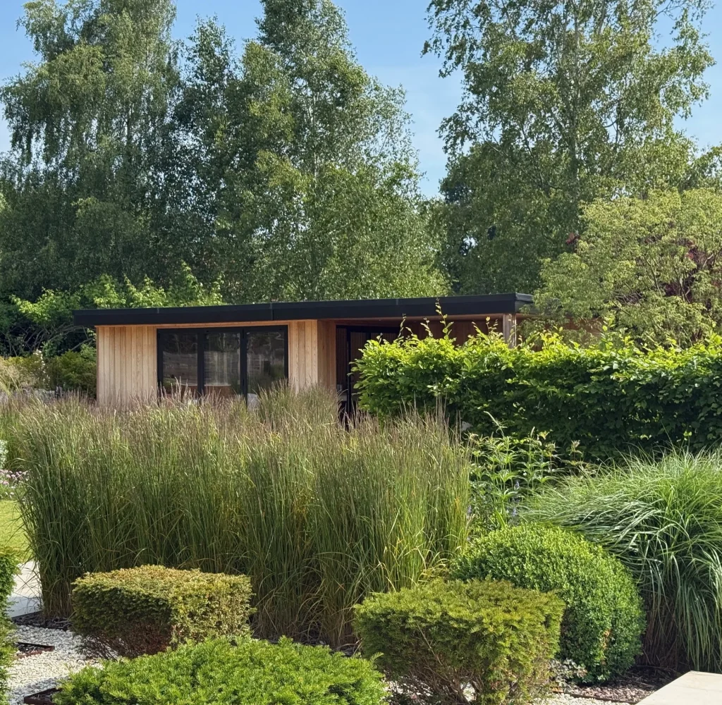 Landscaped garden with raised planters, ornamental grasses and composite decking
